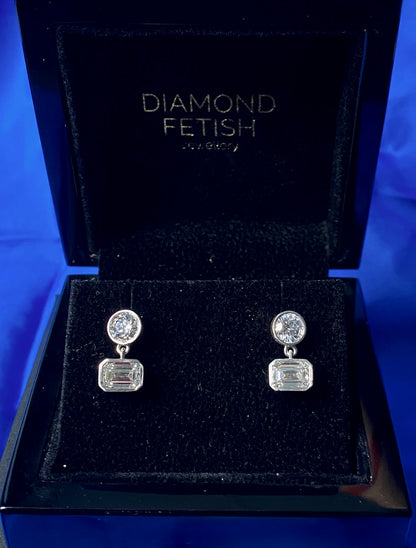 SOHO DROP EARRING, BRILLIANT CUT DIAMOND WITH A EMERALD CUT DROP DIAMOND SET IN 14K GOLD.