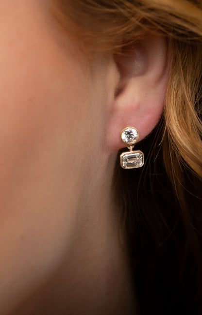 SOHO DROP EARRING, BRILLIANT CUT DIAMOND WITH A EMERALD CUT DROP DIAMOND SET IN 14K GOLD.