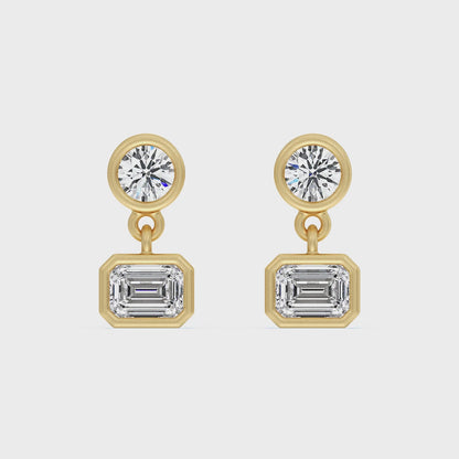 SOHO DROP EARRING, BRILLIANT CUT DIAMOND WITH A EMERALD CUT DROP DIAMOND SET IN 14K GOLD.