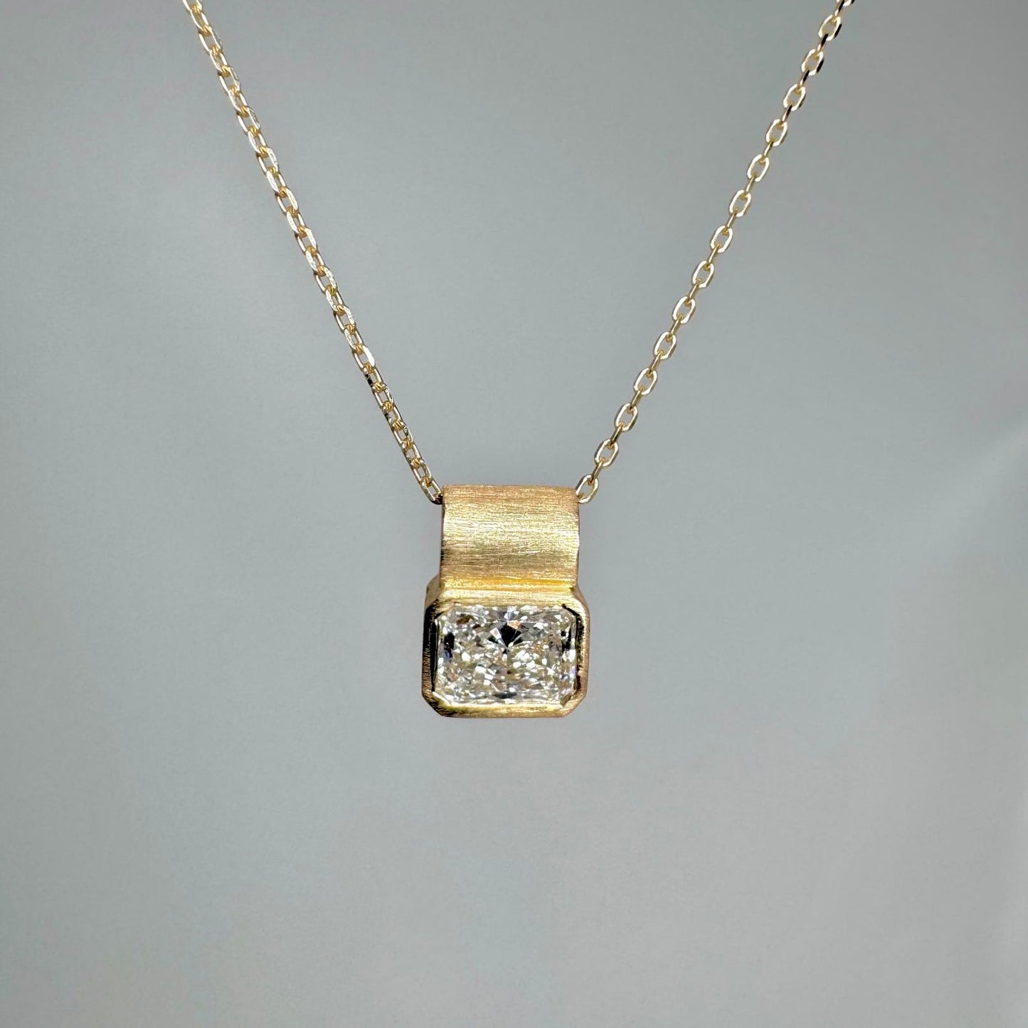 DIAMOND FETISH SOHO PENDANT, RADIANT CUT DIAMOND SET IN 14K GOLD.